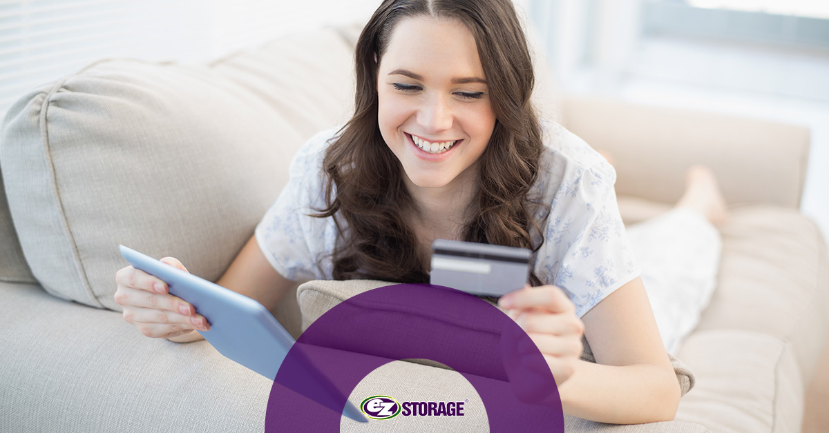 Smiling woman holding tablet and credit card