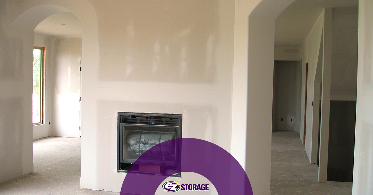 Home undergoing remodeling with EZ Storage logo