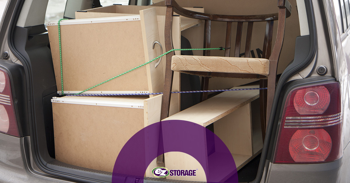 Furniture tied up in a car for moving