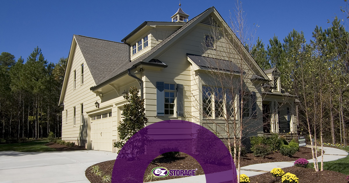 Beige two-story home with text "EZ Storage"