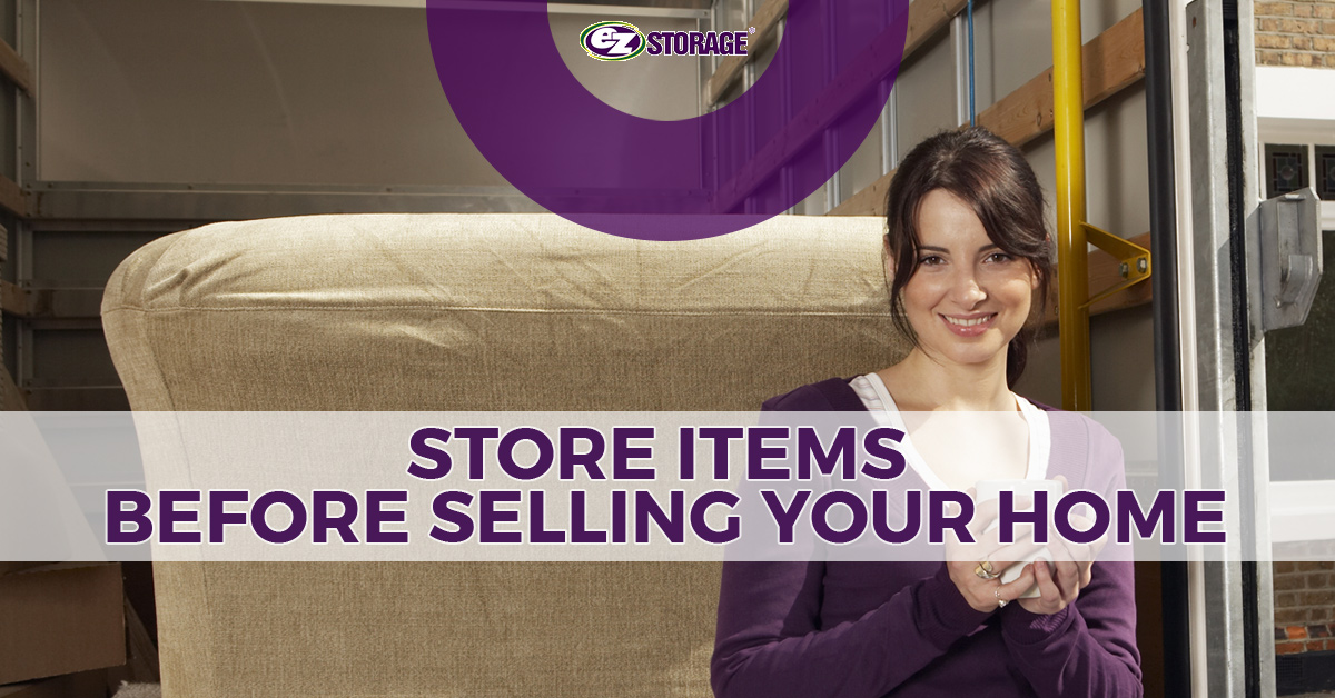 Woman holding a mug standing in front of the back of an open moving truck