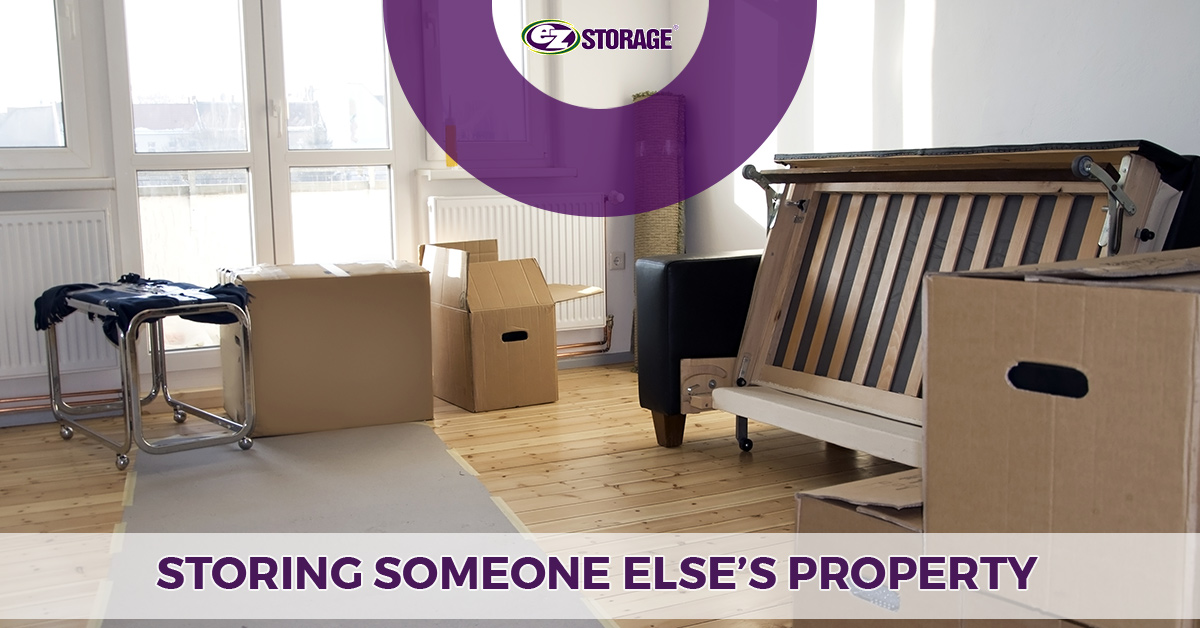 A room with open moving boxes and a sofa bed in the middle of folding up