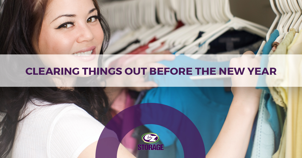 Woman smiling and picking out clothes with EZ Storage logo and text "Clearing Things Out Before the New Year"
