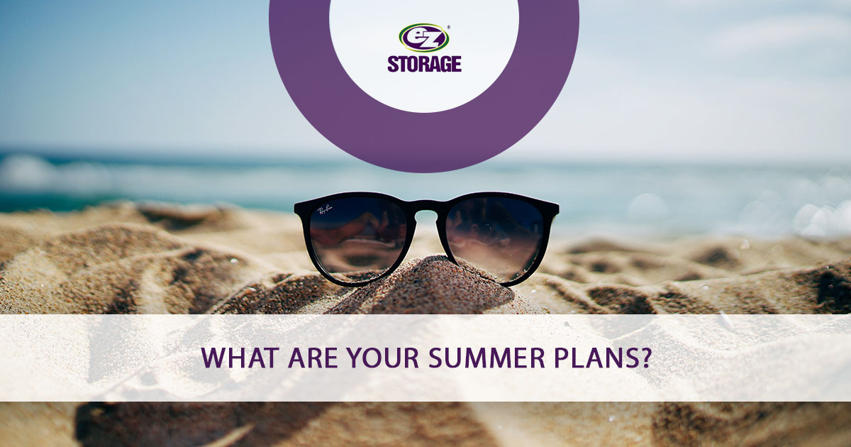 Ray-Ban sunglasses propped up on sand pile with text "What Are Your Summer Plans?"