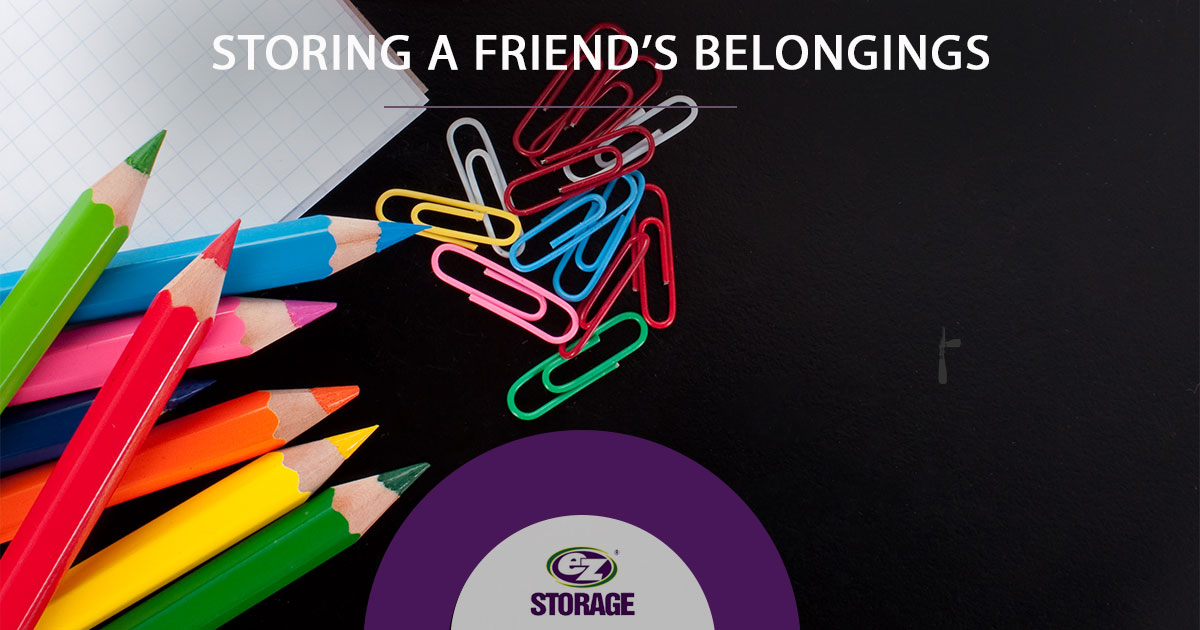Graph paper, color pencils and paperclips on a table and text "Storing a friends belonging"