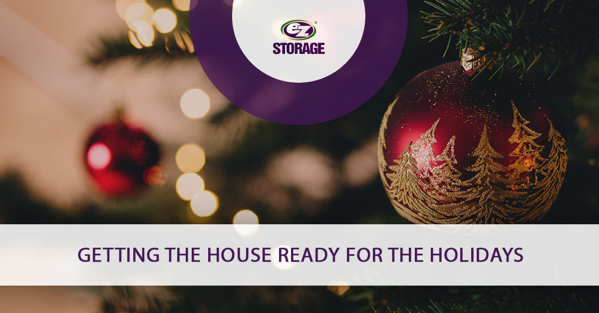 Close up of red oranment on christmas tree and text "Getting the house ready for the holidays"