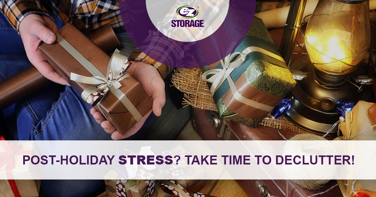 Closeup of man holding holiday presents with banner text "Post-holiday stress? Take time to declutter"