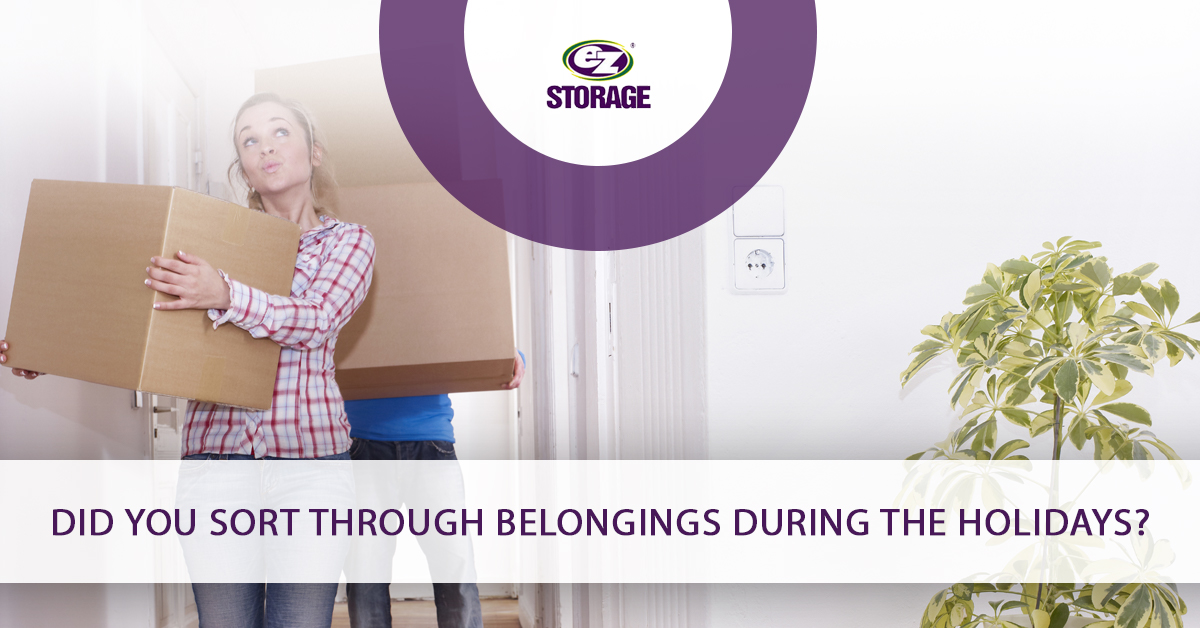 Man and women entering a room with boxes and text "Did you sort through belongings during the holidays?"