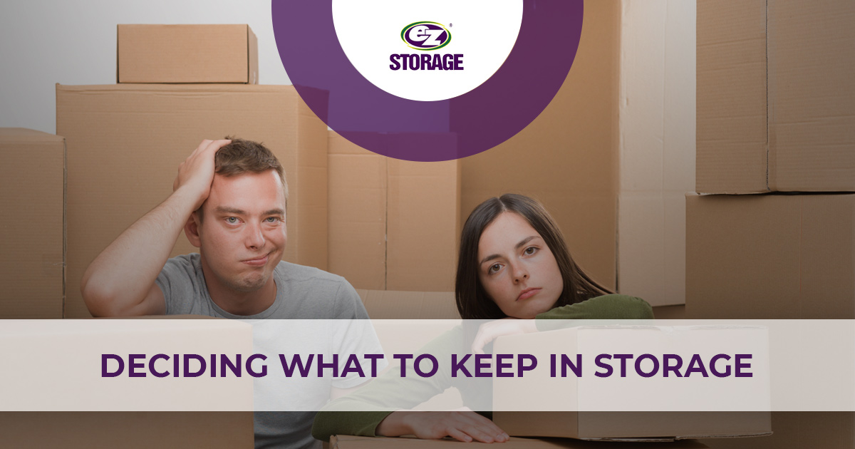 Man and women looking pensive over boxes and text "Deciding what to keep in storage"