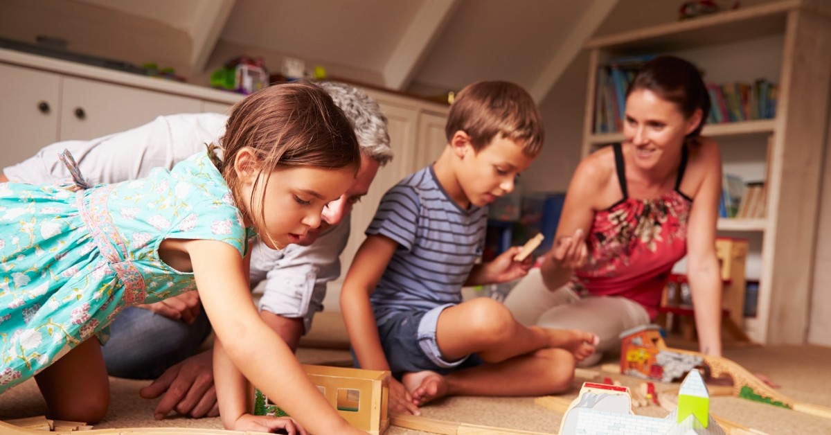 Man and woman playing puzzle games with two children