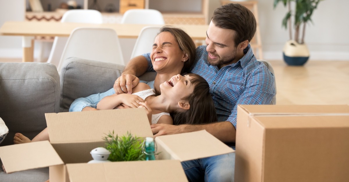 Family hugging and laughing together on the couch