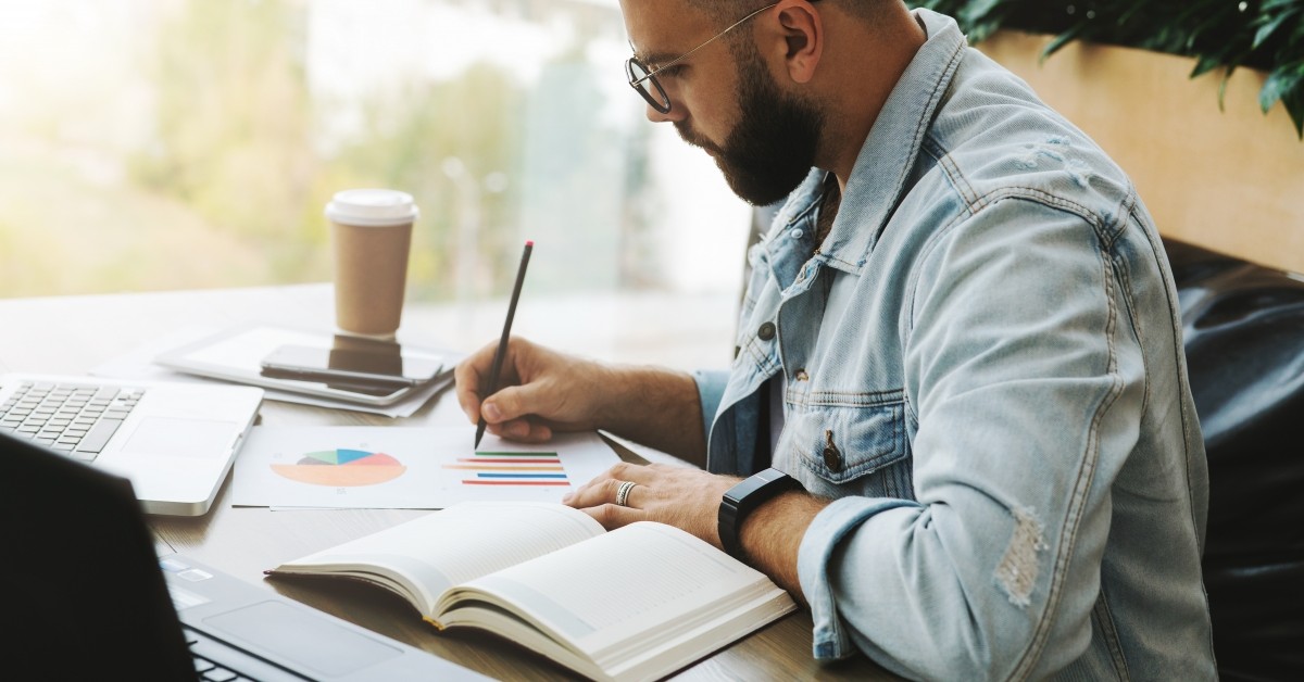 Man sitting at desk with business charts
