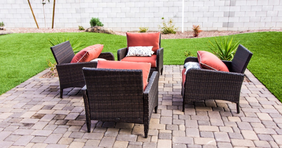 Outdoor patio lounge furniture in fenced-in backyard setting