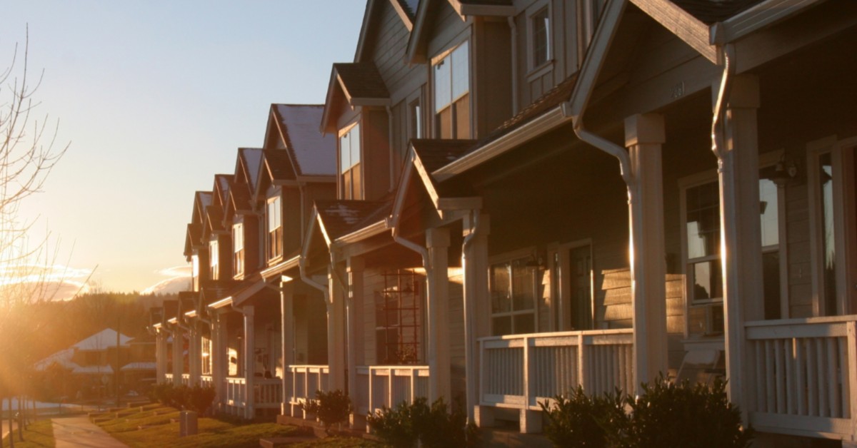 Frontal view of row-houses in residential area with sun setting.