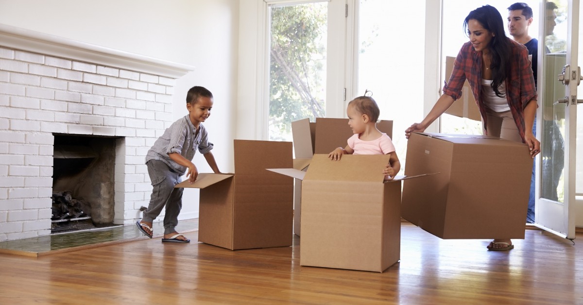 Kids playing in moving boxes with parents
