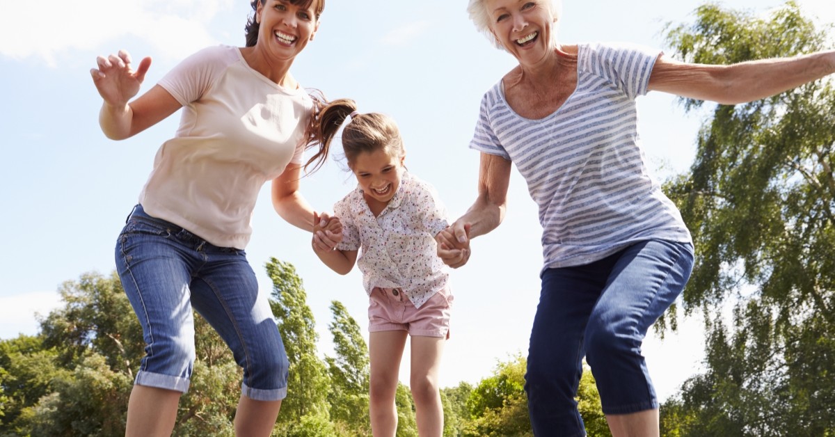 Grandmother, mother, daughter having fun outdoors