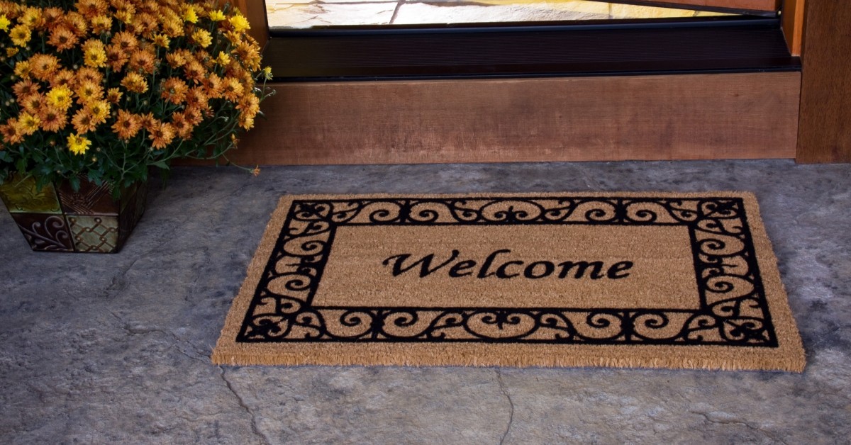 Closeup of welcome home mat at front door