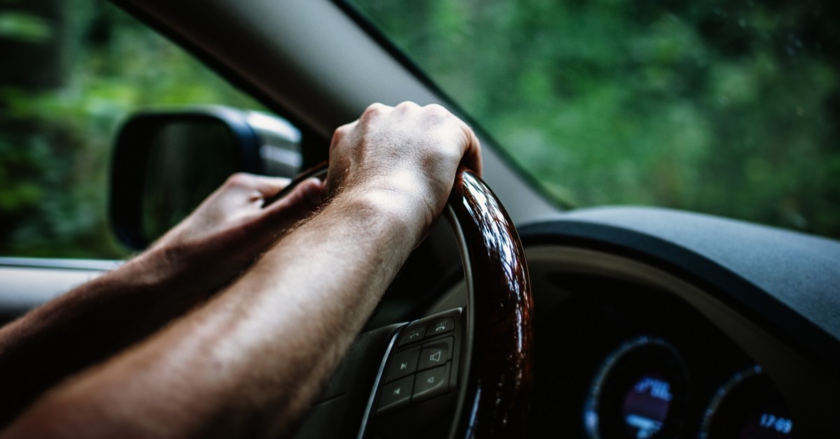 Hands on steering wheel of luxury vehicle