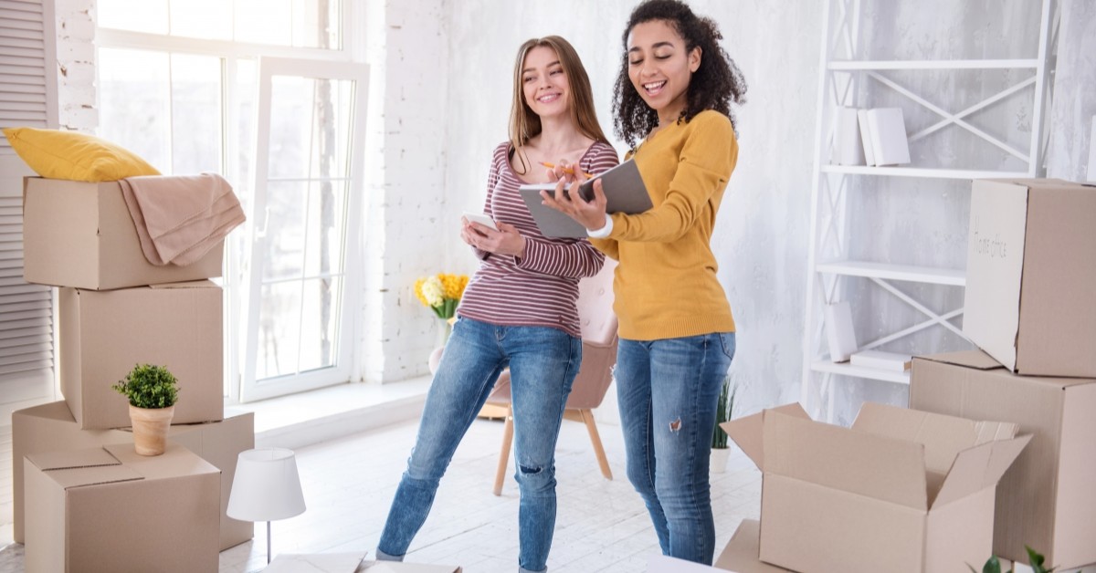 Two female roommates moving into apartment