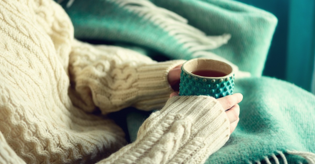 Closeup of woman's hands holding a warm cup of tea