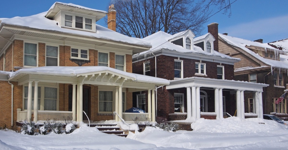 Snowy exterior of homes during daylight